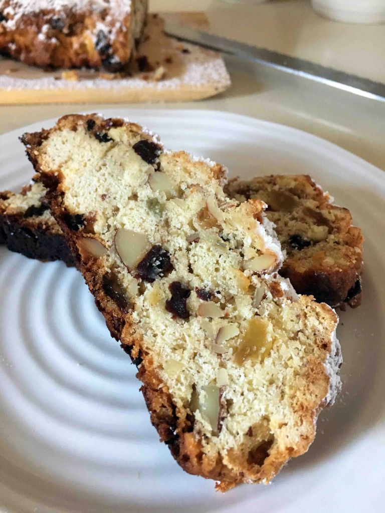Two slices of german christmas stollen on a white plate