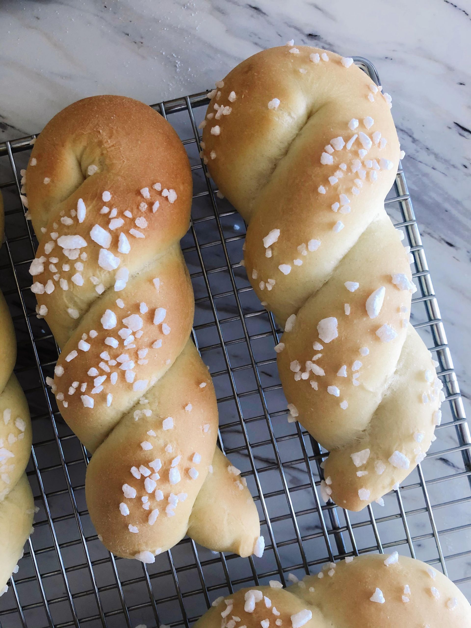 Two twists of sweet yeast dough after being rolled in pearl sugar and baked to a golden brown