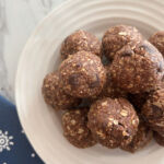 A pile of grammie's no-bake chocolate energy bites on a white plate.