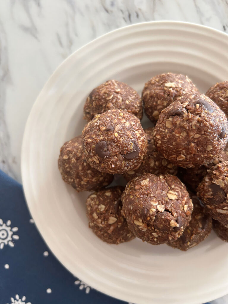 A pile of grammie's no-bake chocolate energy bites on a white plate.